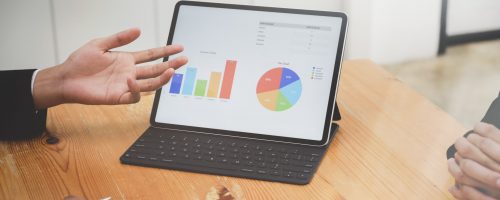 Close-up view of young successful businessman presenting his strategy to coworkers