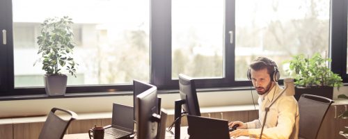 Canva - Man With Headphones Facing Computer Monitor